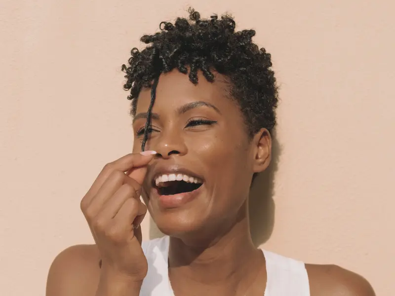 woman laughing with beautiful coily hair