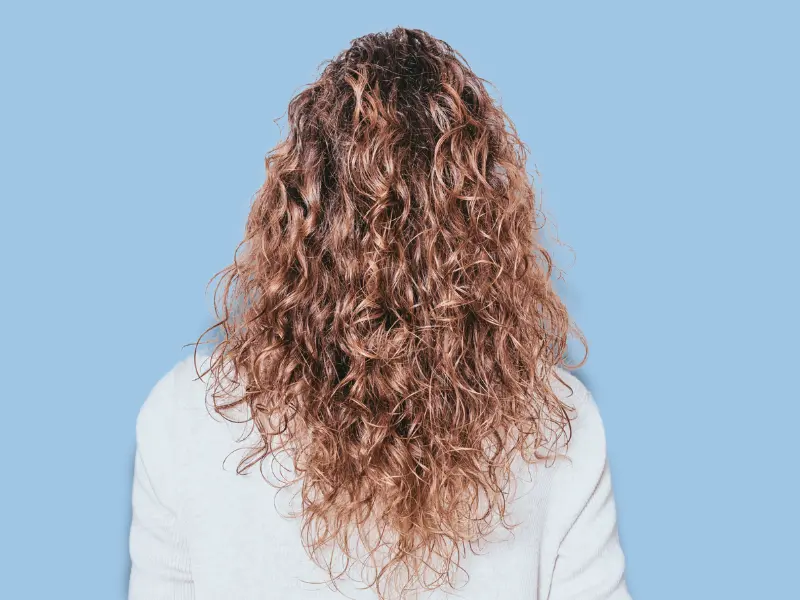 Woman with shiny and healthy curly hair